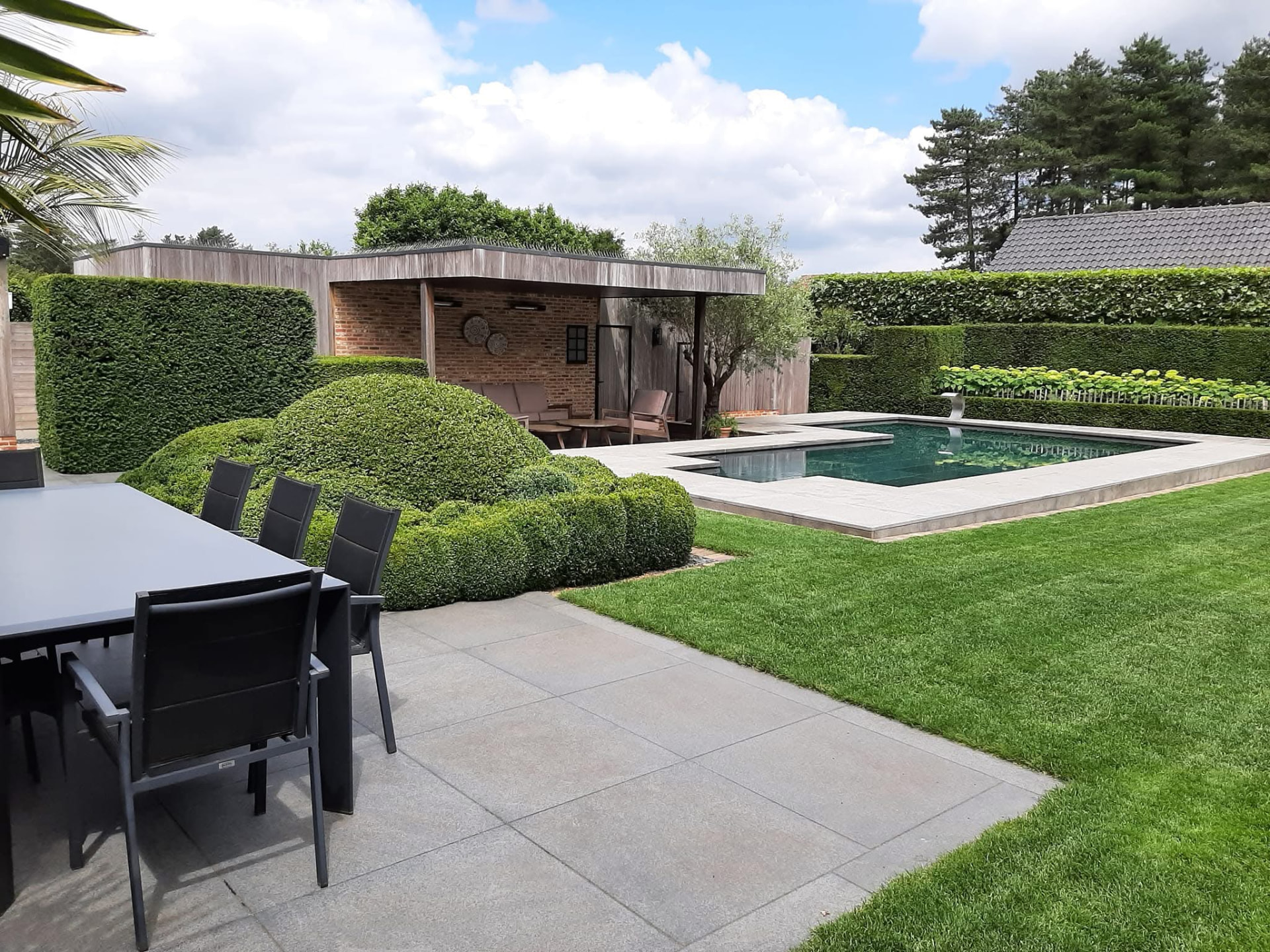 Tuin met zwembad, poolhouse en gesnoeide hagen